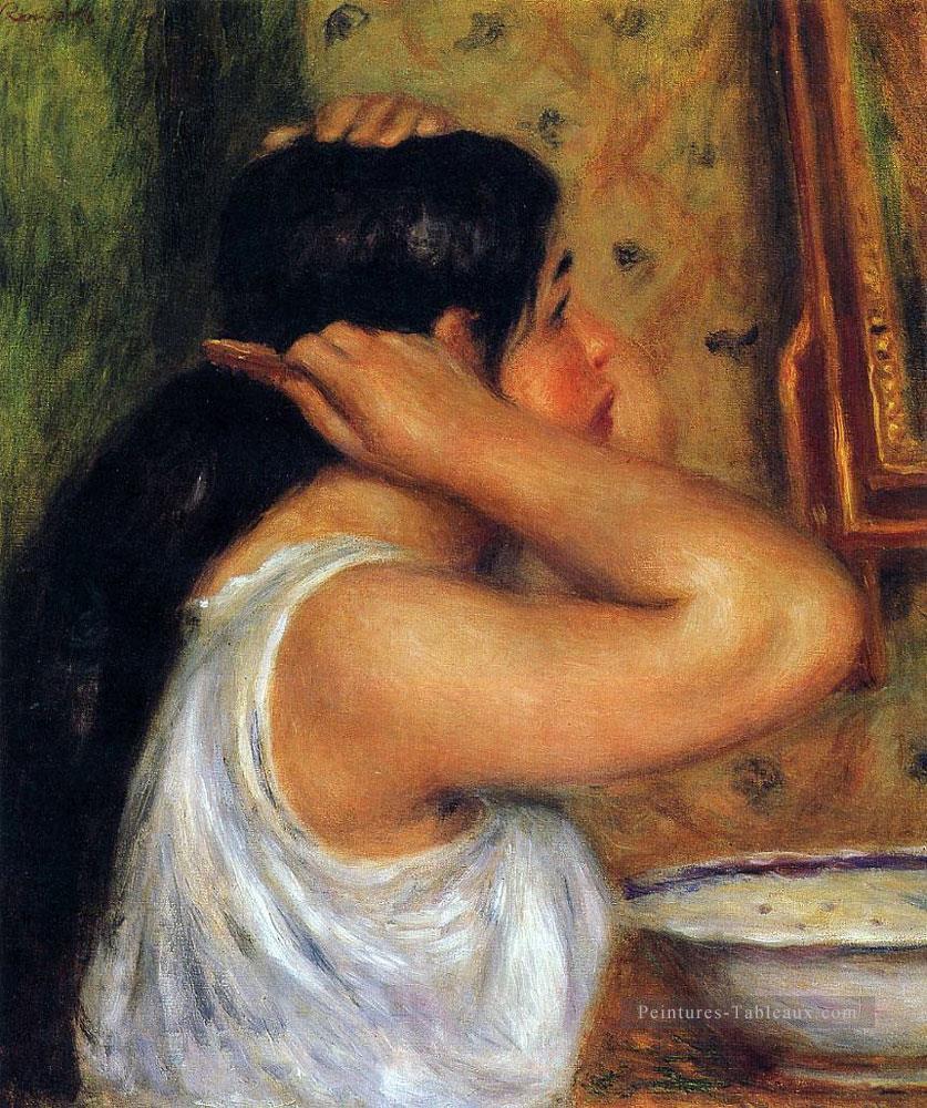 femme se peignant les cheveux Pierre Auguste Renoir Peintures à l'huile